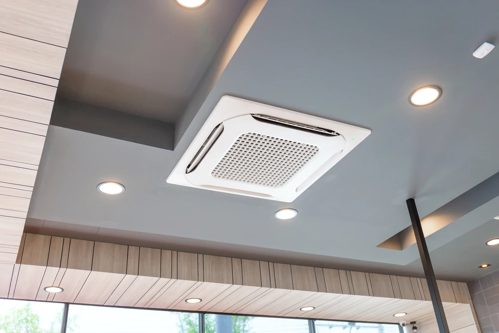 Plafond moderne d'intérieur avec climatiseur cassette carré encastré au centre